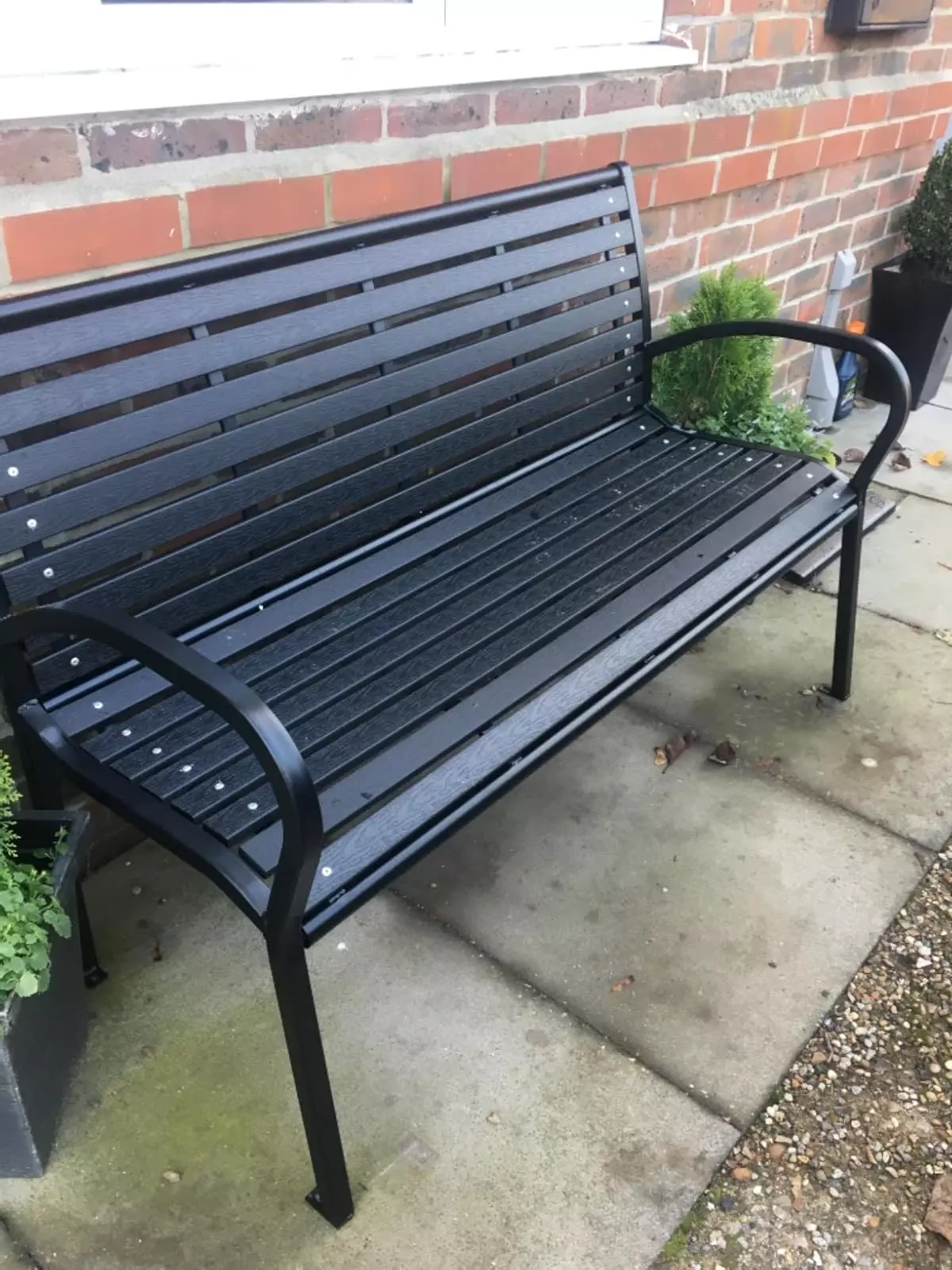 black metal bench with armrest for yard or patio
