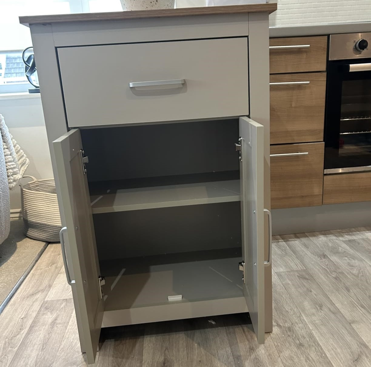 Grey kitchen island table with adjustable inner shelf