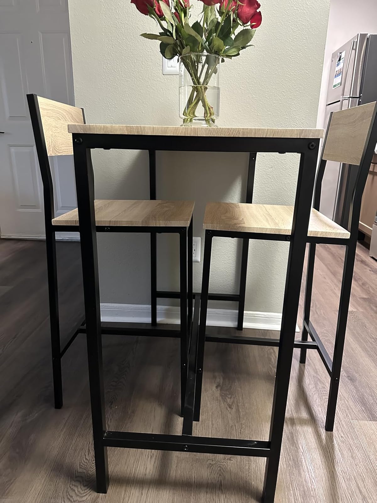 tall dining table and two stools made from wood with metal frame