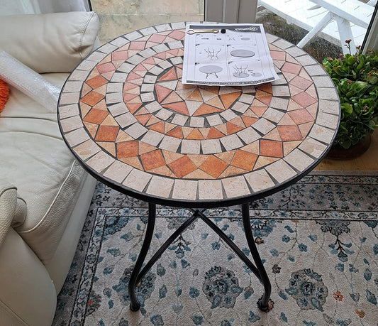 Round mosaic table with a patterned top in a living room