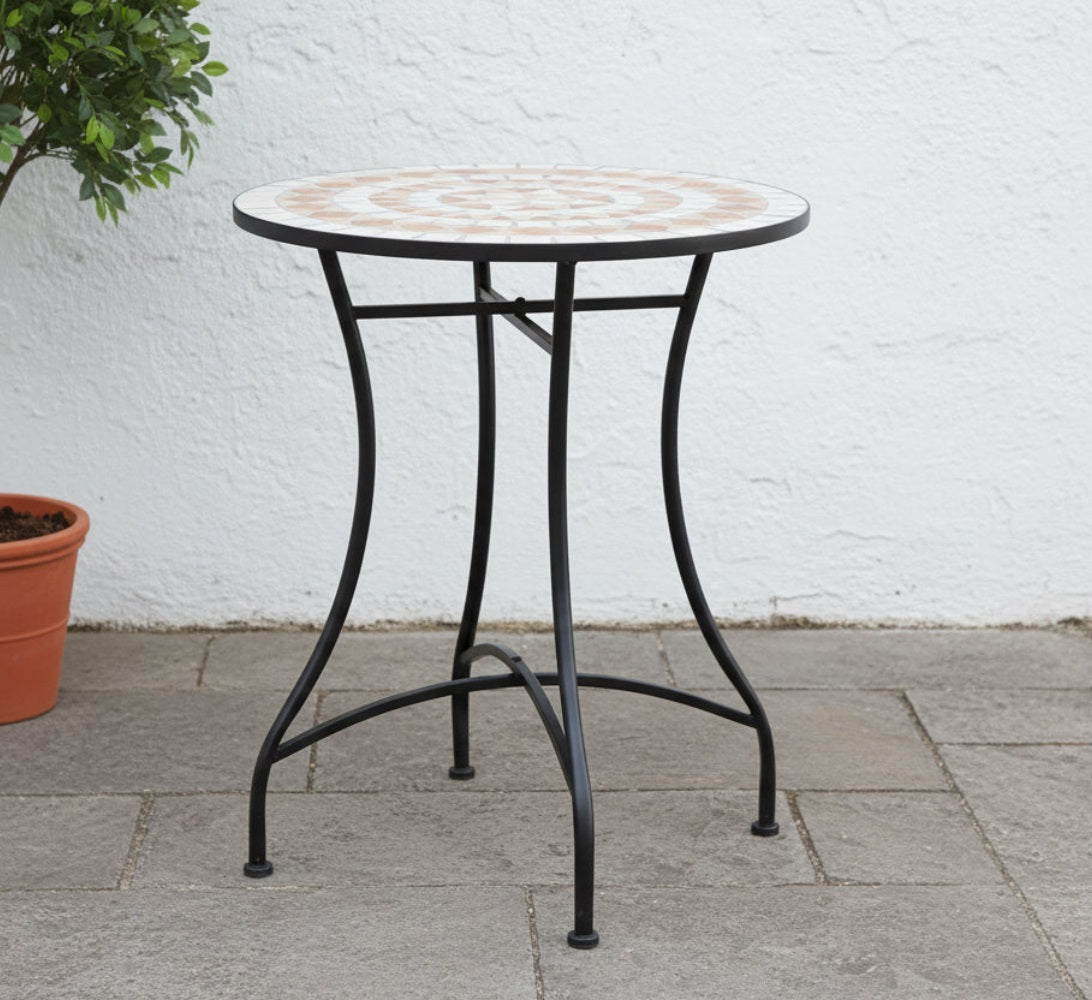 Round metal table with a patterned top on a patio